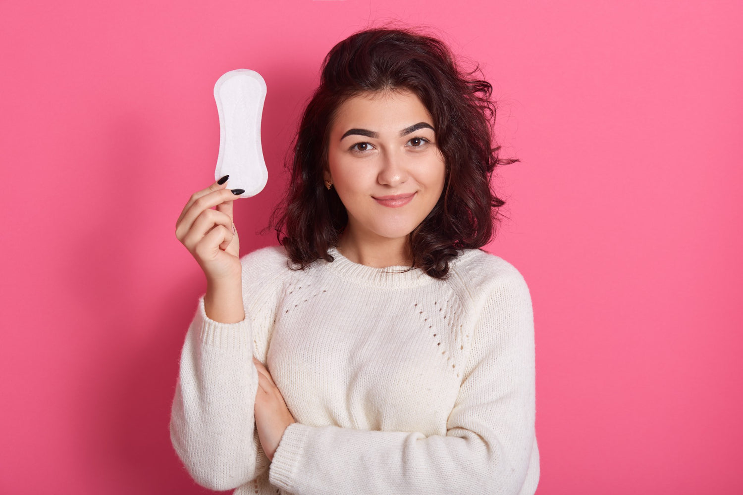 Woman holding sanitary pad in hand